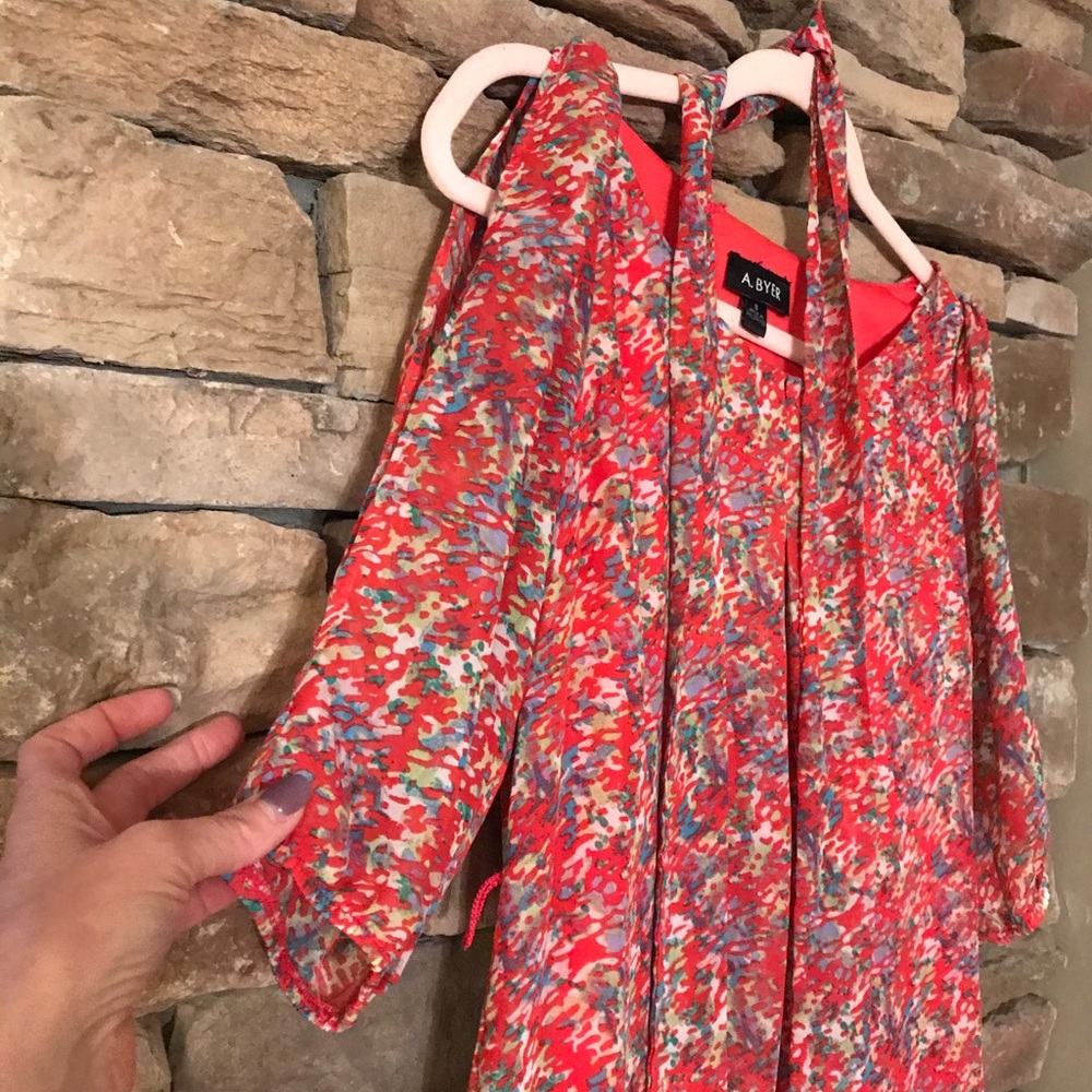 Cute trendy dress with open shoulder/arm.